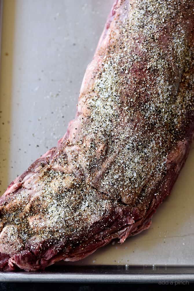 Beef Tenderloin covered in Stone House Seasoning to dry brine the beef, all on a rimmed baking sheet.