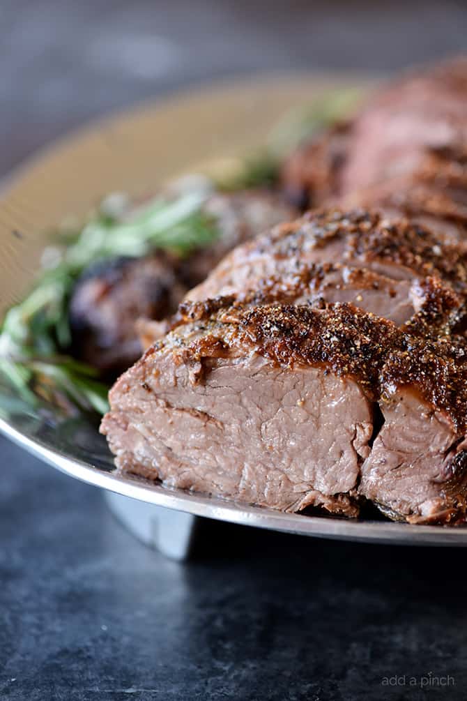 Side picture of juicy beef sliced on a pewter platter.