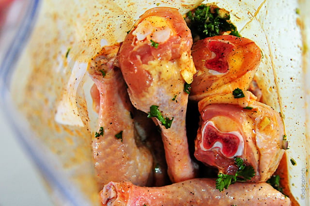 View inside a plastic zip bag with chicken legs in marinade // addapinch.com