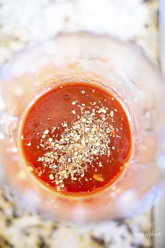 Sauce for cashew chicken is mixed in glass container.