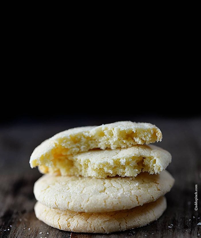 Stack of sugar cookies with top cookie broken to show crumb texture.
