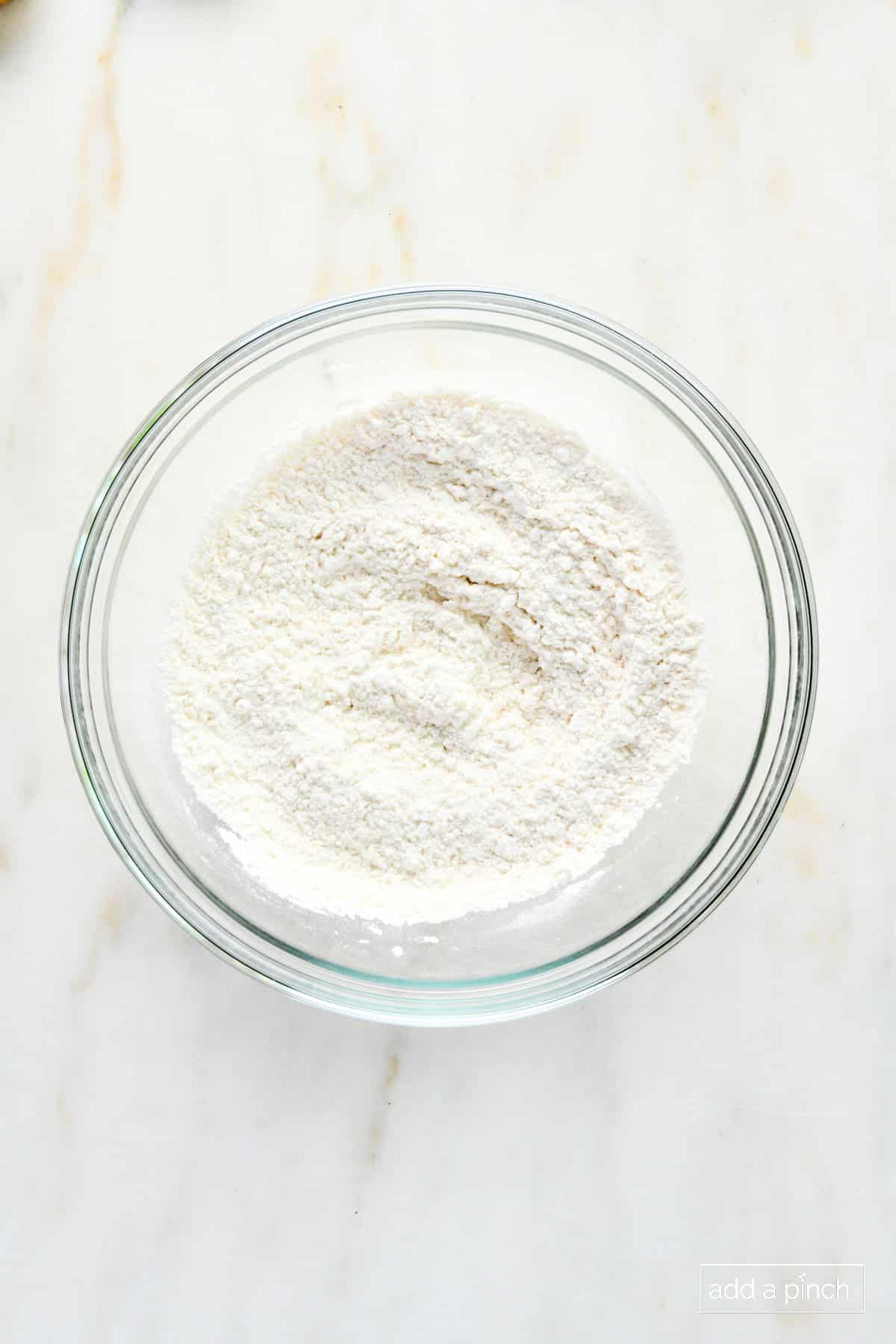 Flour mixture for cobbler crust in a glass bowl.