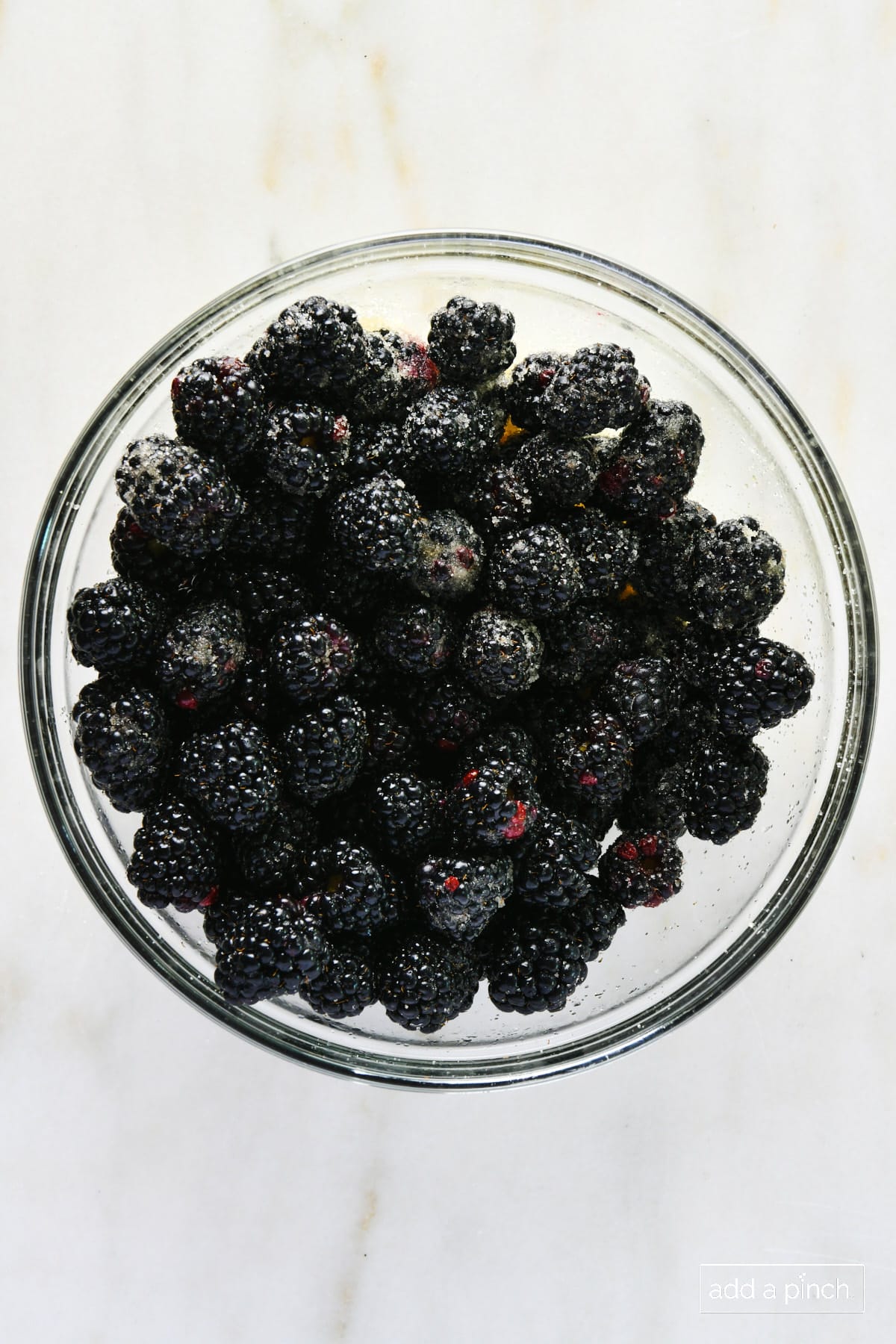 Sugared blackberries in a glass bowl.