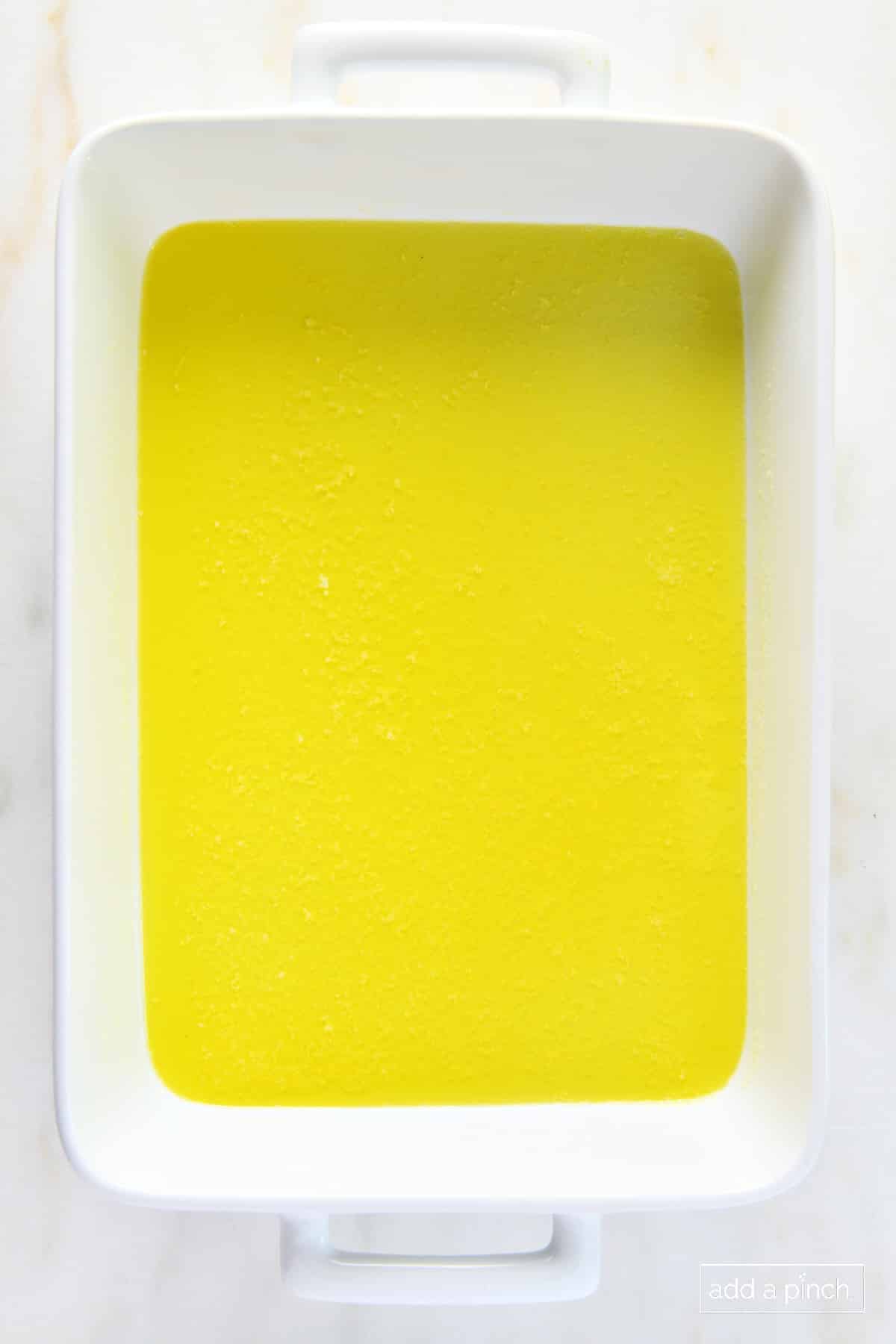 Melted butter in a white baking dish.