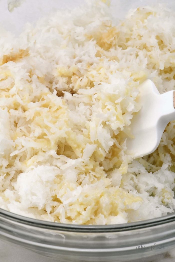 Coconut Macaroon mixture in glass bowl, marble counter.