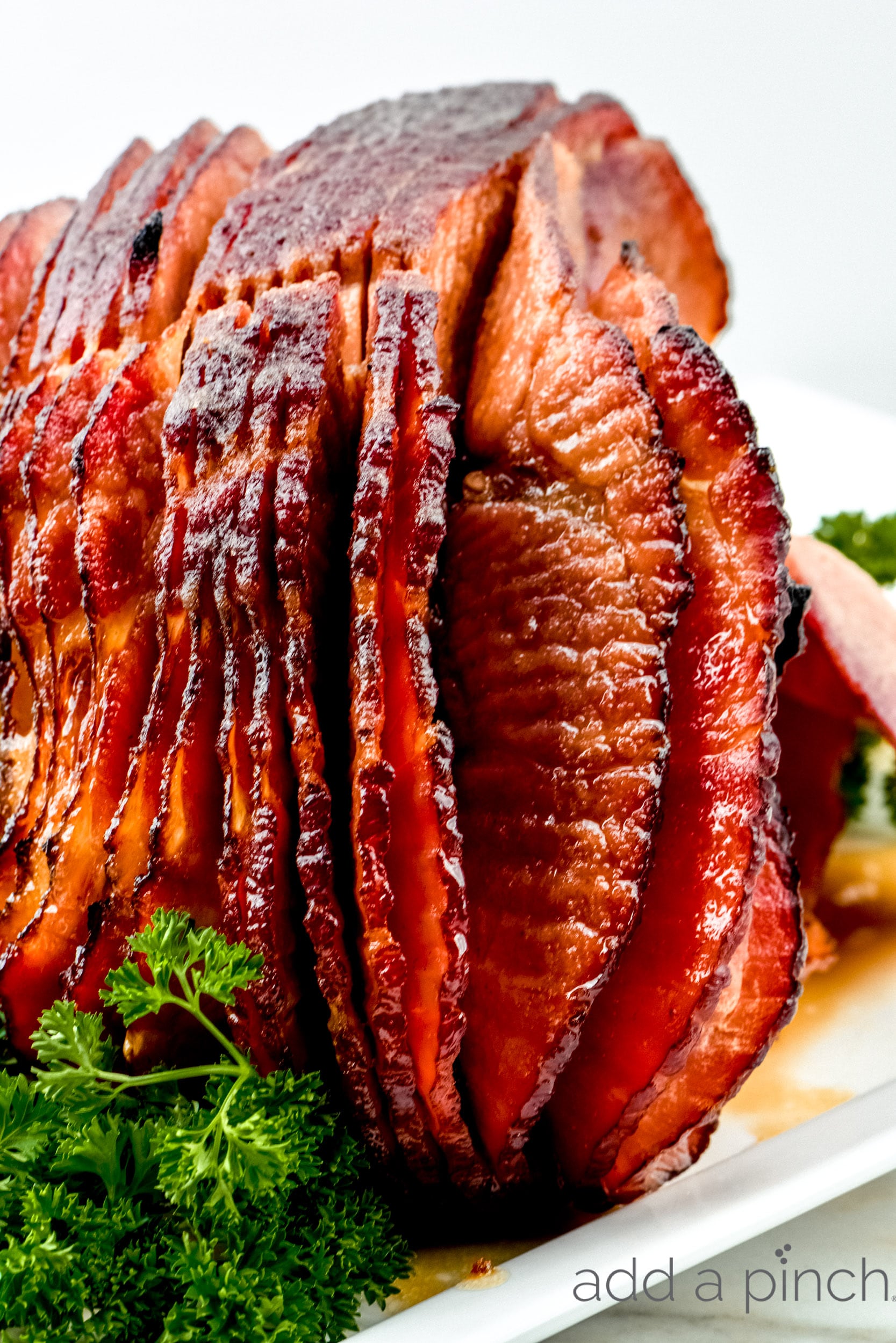 Cola Glazed Ham Recipe
on serving platter with garnish.