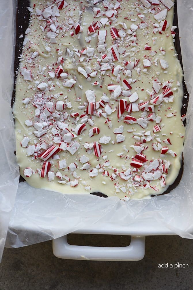 Peppermint Bark spread onto wax paper lined dish.