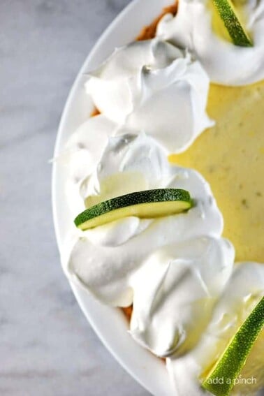 Key Lime Pie Recipe - Key Lime Pie makes a classic, refreshing dessert recipe. Made of simple ingredients, this updated key lime pie recipe comes together quickly and chills to a light and airy consistency for an elegant dessert.
