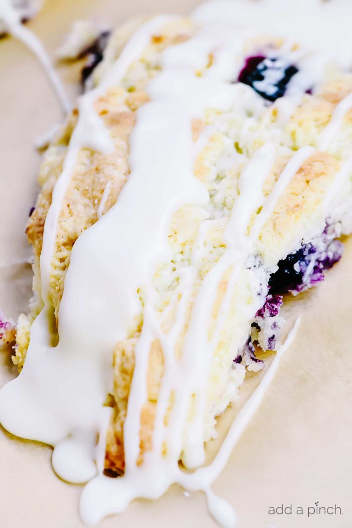 Lemon blueberry scones drizzled with glaze.