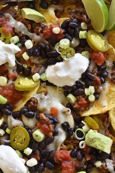 Sheet Pan Nachos Recipe - Sheet Pan Nachos make a quick and easy appetizer for a crowd or easy weeknight supper! These nachos are always a favorite.
