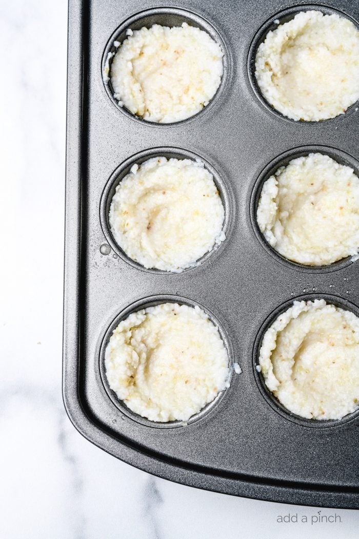 Grits pressed into a muffin tin to bake.