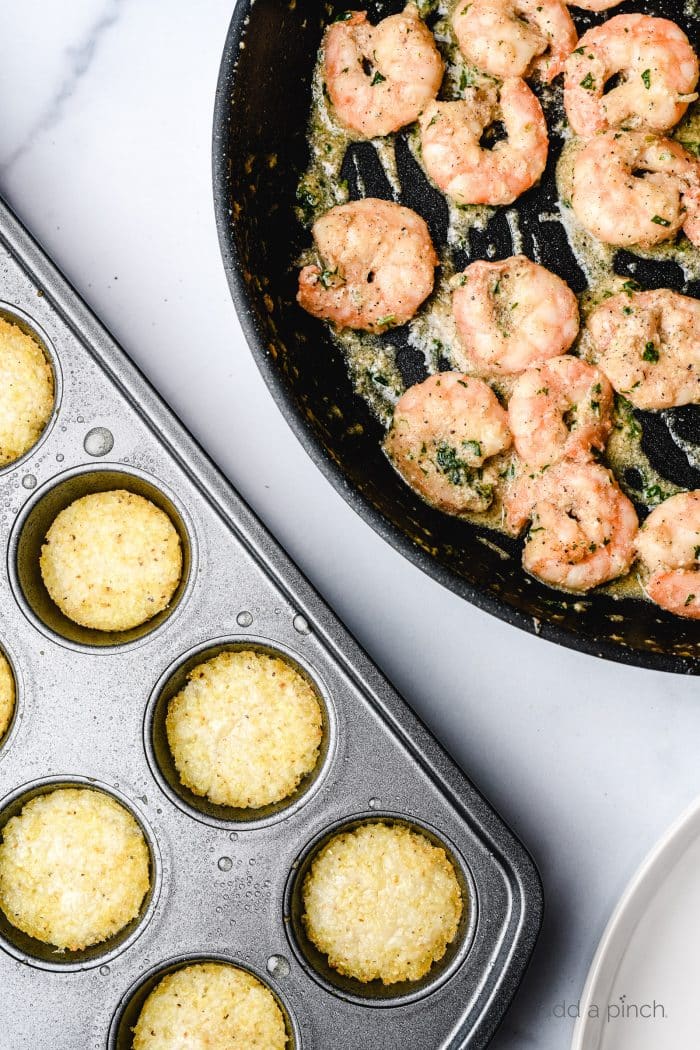 Shrimp and Grits cooking in butter in skillet and baked grits in muffin tin.