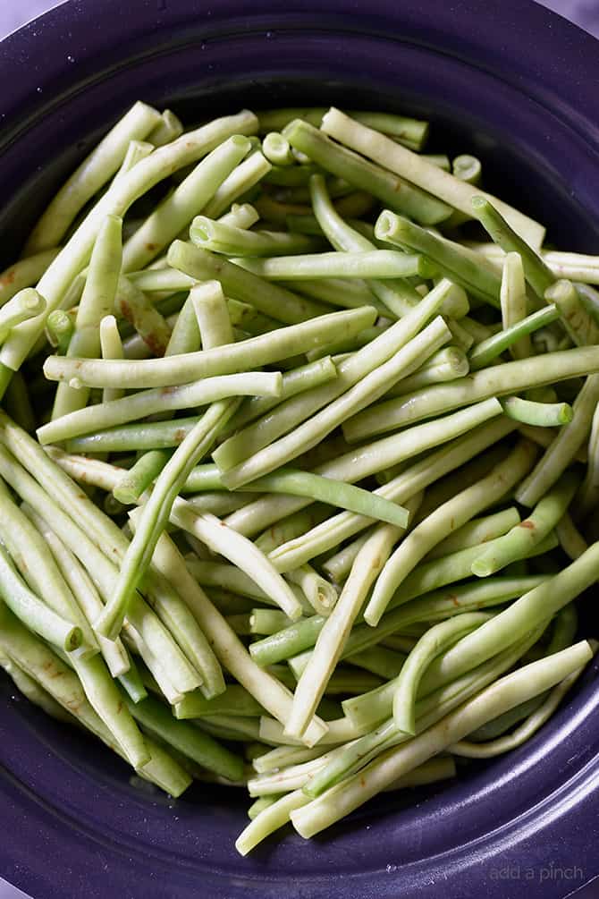 Slow Cooker Green Beans Recipe - These are the best slow cooker green beans and have everyone coming back for more! // addapinch.com