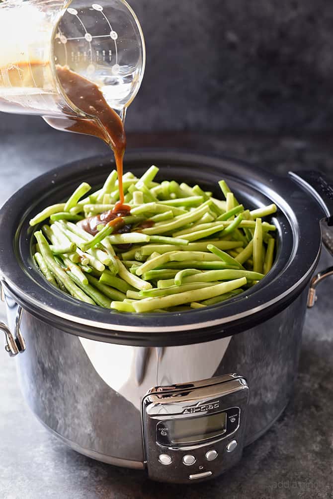 Slow Cooker Green Beans Recipe - These are the best slow cooker green beans and have everyone coming back for more! // addapinch.com