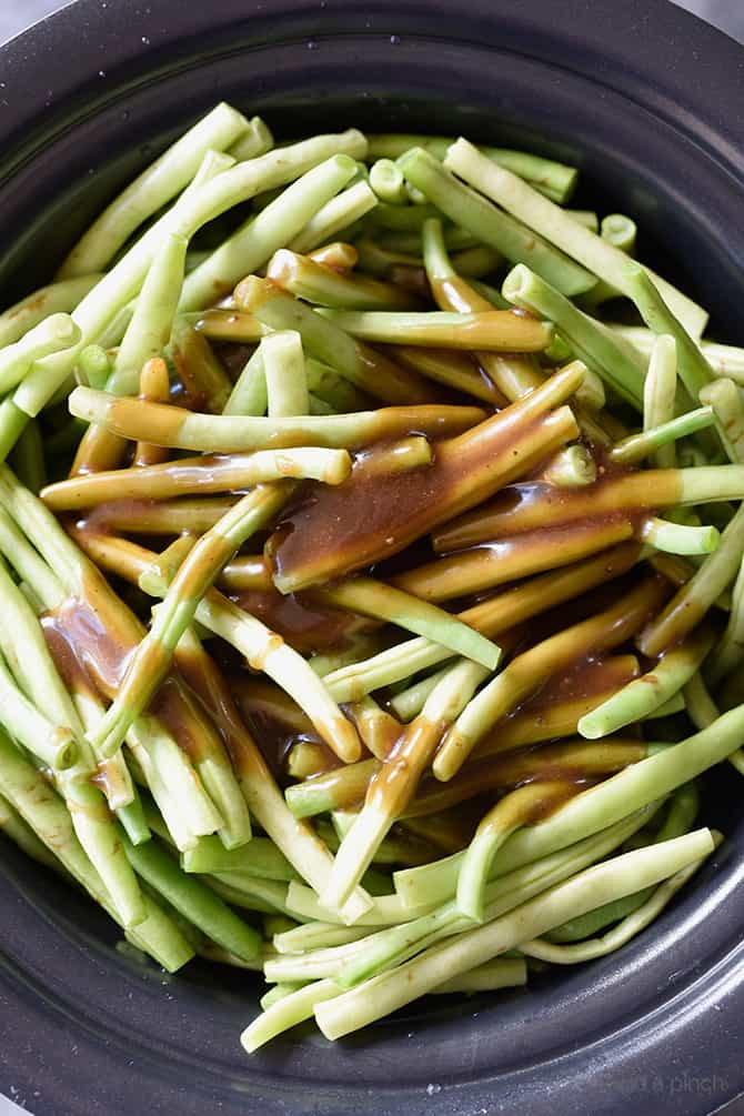 Slow Cooker Green Beans Recipe - These are the best slow cooker green beans and have everyone coming back for more! // addapinch.com