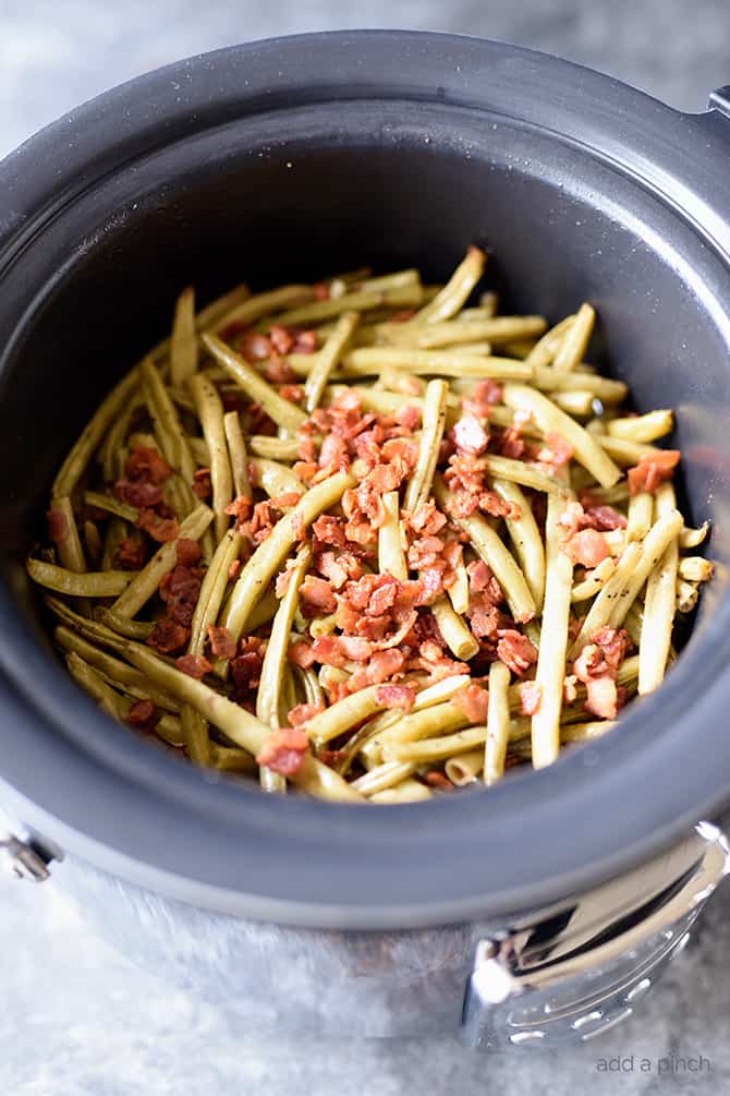 Slow Cooker Green Beans Recipe - These are the best slow cooker green beans and have everyone coming back for more! // addapinch.com