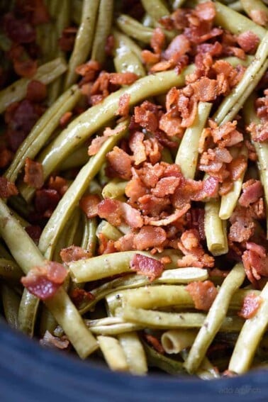Slow Cooker Green Beans Recipe - These are the best slow cooker green beans and have everyone coming back for more!ย // addapinch.com