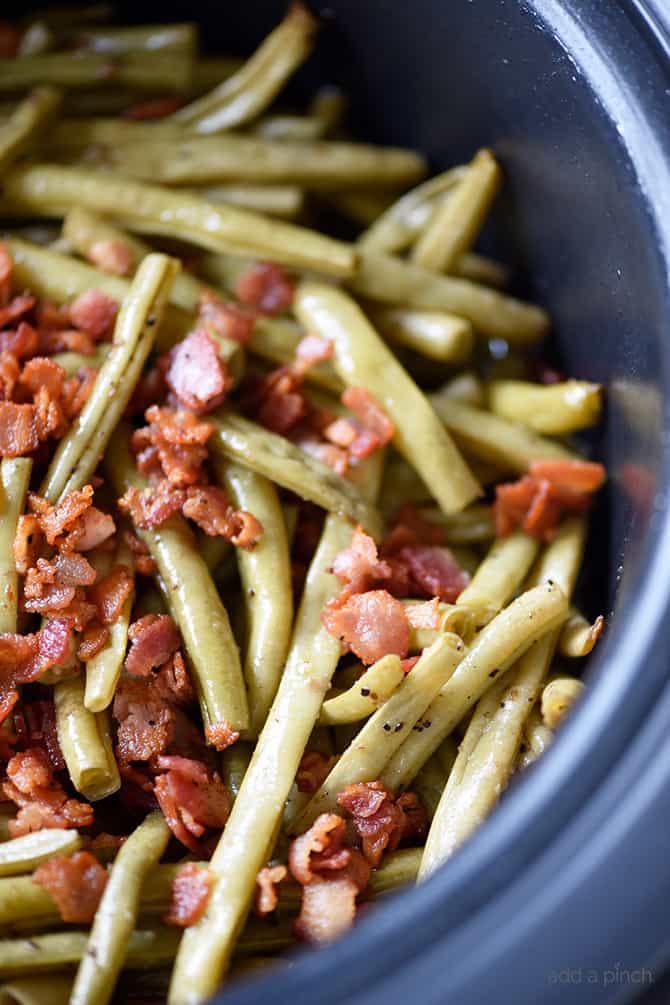 Slow Cooker Green Beans Recipe - These are the best slow cooker green beans and have everyone coming back for more! // addapinch.com