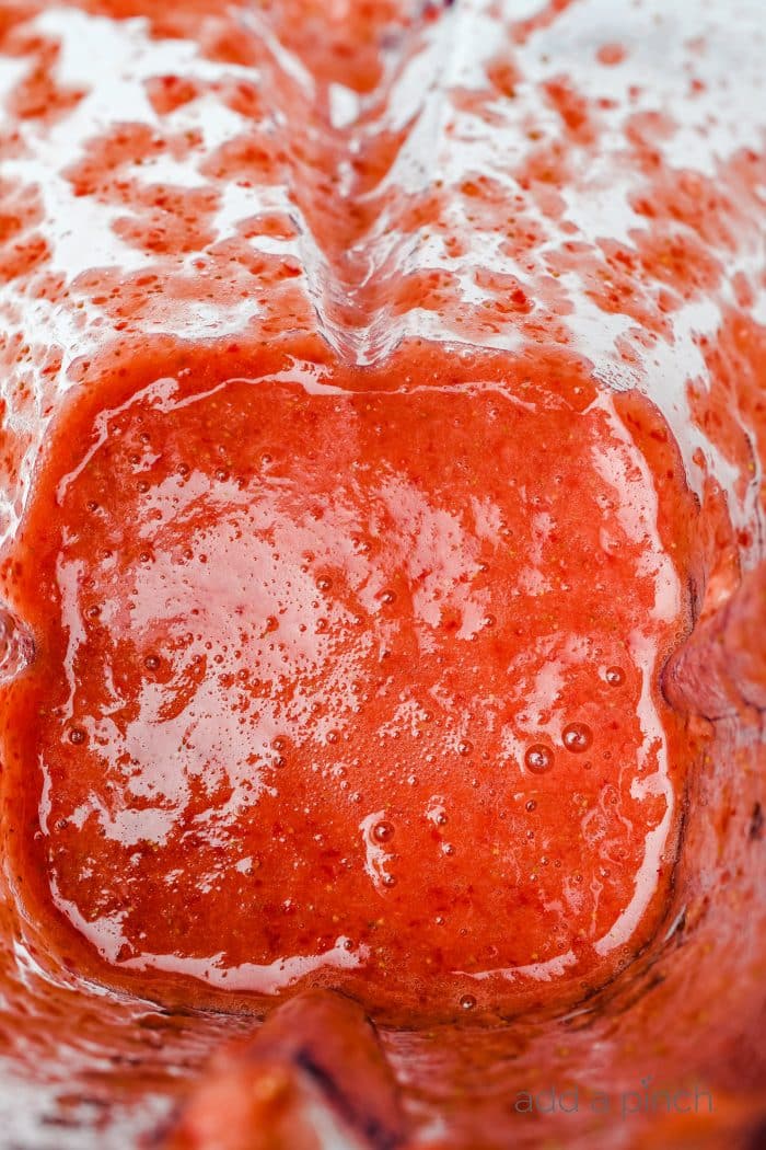 Blended strawberry puree from fresh strawberries pulsed in a blender jar.